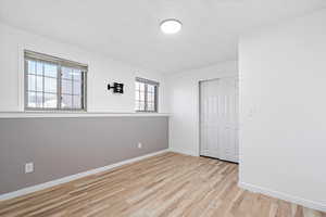 Spare room with light wood-type flooring and baseboards