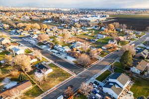Aerial view of property and surrounding area featuring nearby suburban area
