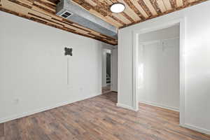 Unfurnished bedroom with wood finished floors, a closet, and wooden ceiling
