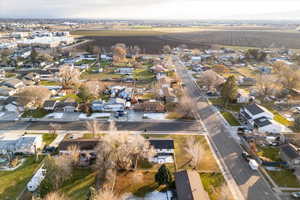 Aerial view of property and surrounding area featuring nearby suburban area