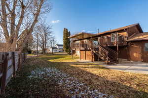 Rear view of property with a wooden deck and stairway