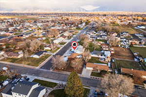 Aerial view of property and surrounding area with nearby suburban area