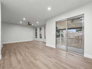 Unfurnished room with light wood-style flooring, a ceiling fan, and recessed lighting