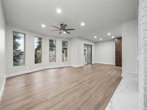 Unfurnished living room featuring light wood-style floors, recessed lighting, and ceiling fan