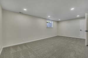 Below grade area featuring light carpet and recessed lighting