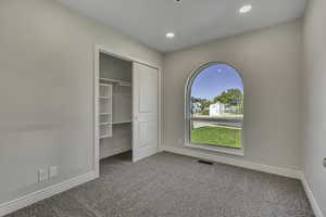 Unfurnished bedroom featuring light colored carpet, a closet, and recessed lighting