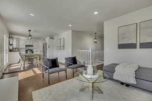 Living room with recessed lighting and light wood-style flooring