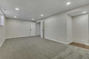 Below grade area featuring light colored carpet and recessed lighting