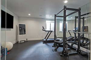 Workout room featuring recessed lighting