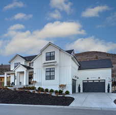 Modern inspired farmhouse with board and batten siding, a shingled roof, driveway, a garage, and a porch