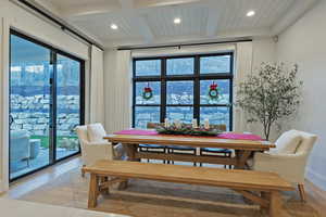 Dining room with beamed ceiling, plenty of natural light, recessed lighting, and light wood-type flooring