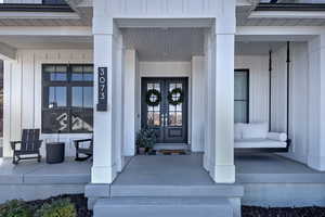 Doorway to property featuring a porch and board and batten siding