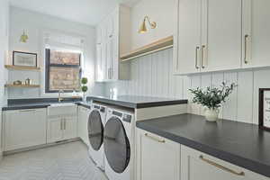 Laundry area featuring cabinet space and washing machine and dryer