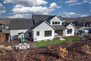 Back of property with board and batten siding, a shingled roof, and a mountain view