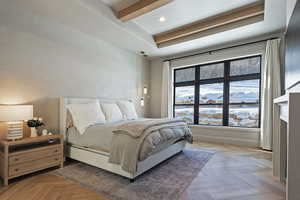 Bedroom with beam ceiling, recessed lighting, and a fireplace with flush hearth