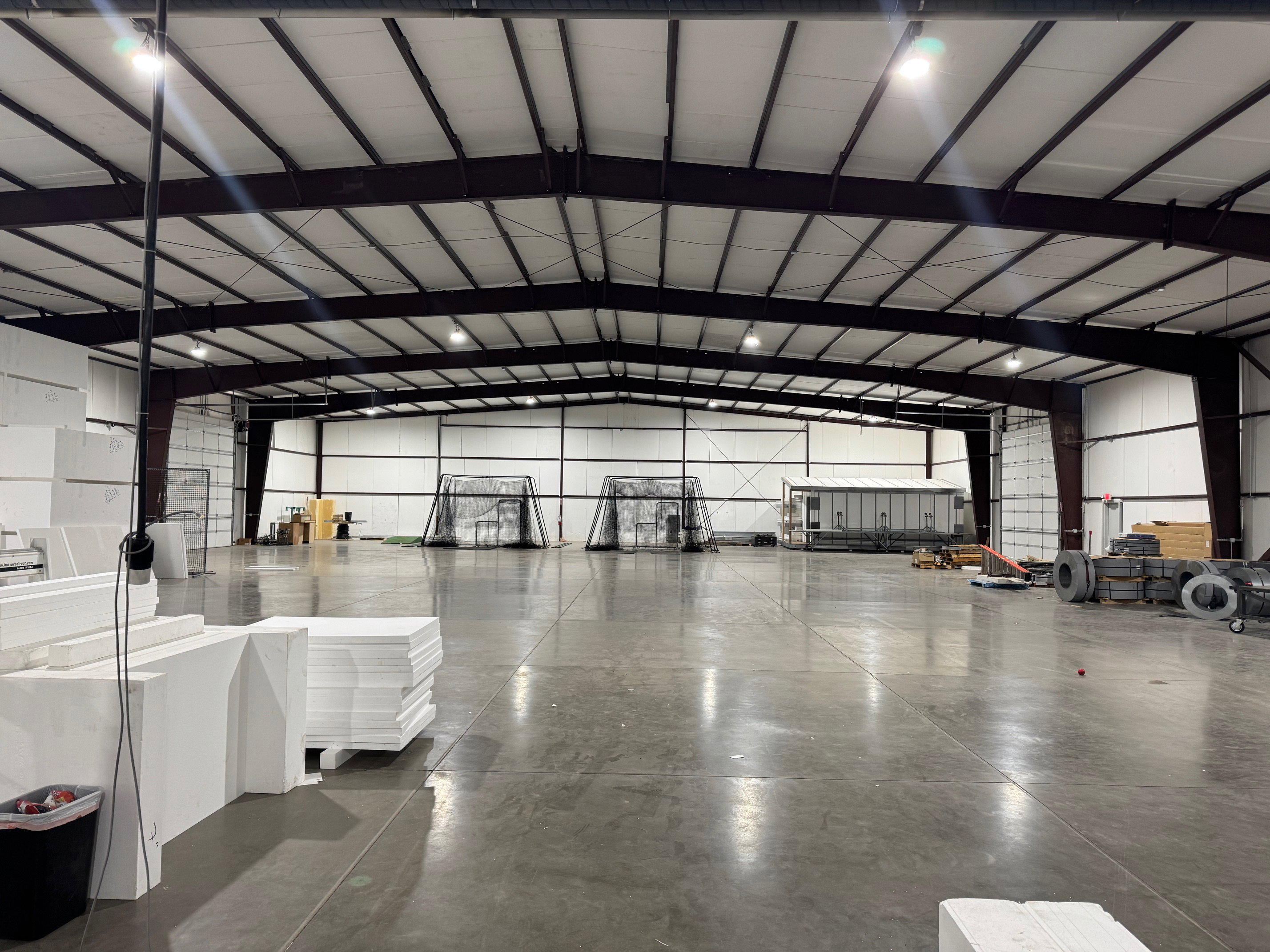 Misc room featuring vaulted ceiling and metal wall