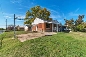 Rear view of property featuring brick siding