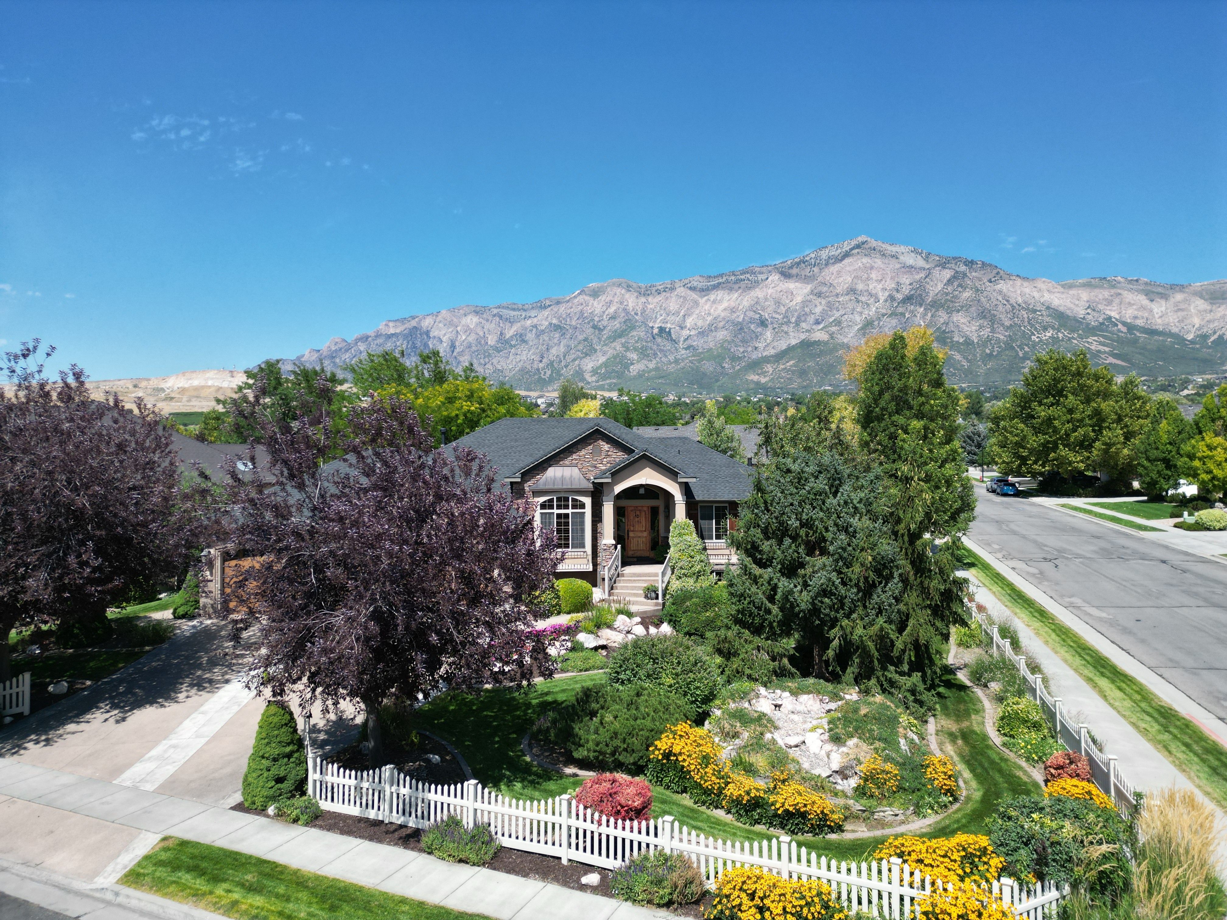 View of front of home with a mountain view and a fenced front yard