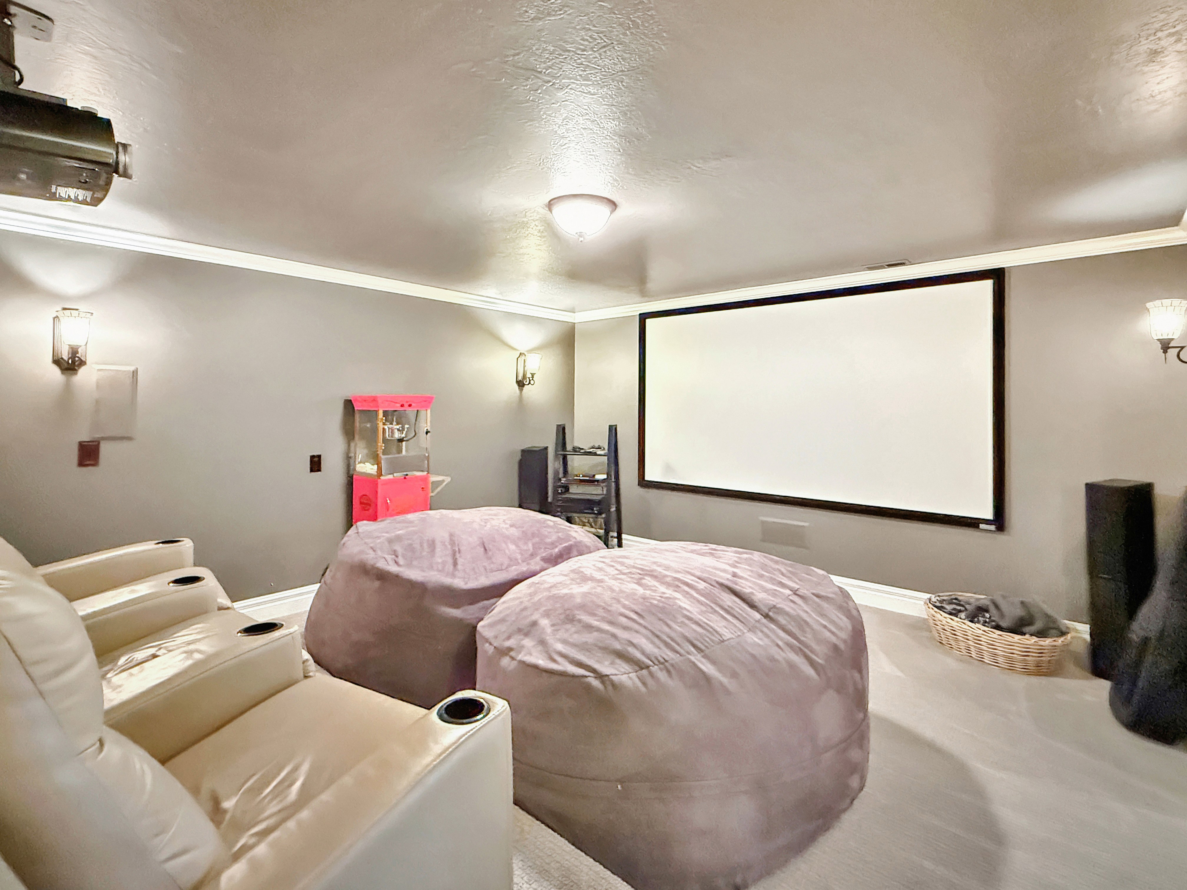 Home theater with crown molding and a textured ceiling