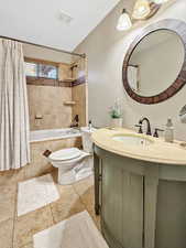 Bathroom with vanity and tiled shower / bath