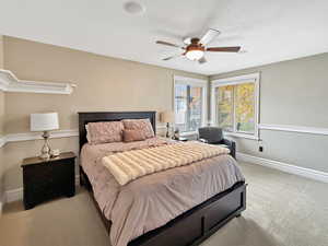 Bedroom featuring light colored carpet and ceiling fan