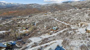 Snowy aerial view featuring a mountain view