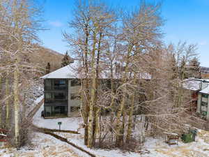 View of snow covered rear of property