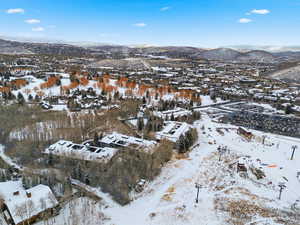 Snowy aerial view featuring a mountain view