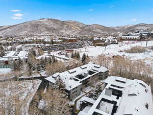 Snowy aerial view featuring a mountain view