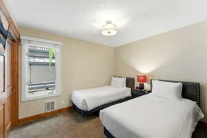 Carpeted bedroom with baseboards