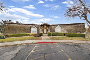 View of property featuring uncovered parking