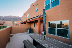 View of back patio featuring area for grilling and a mountain view.