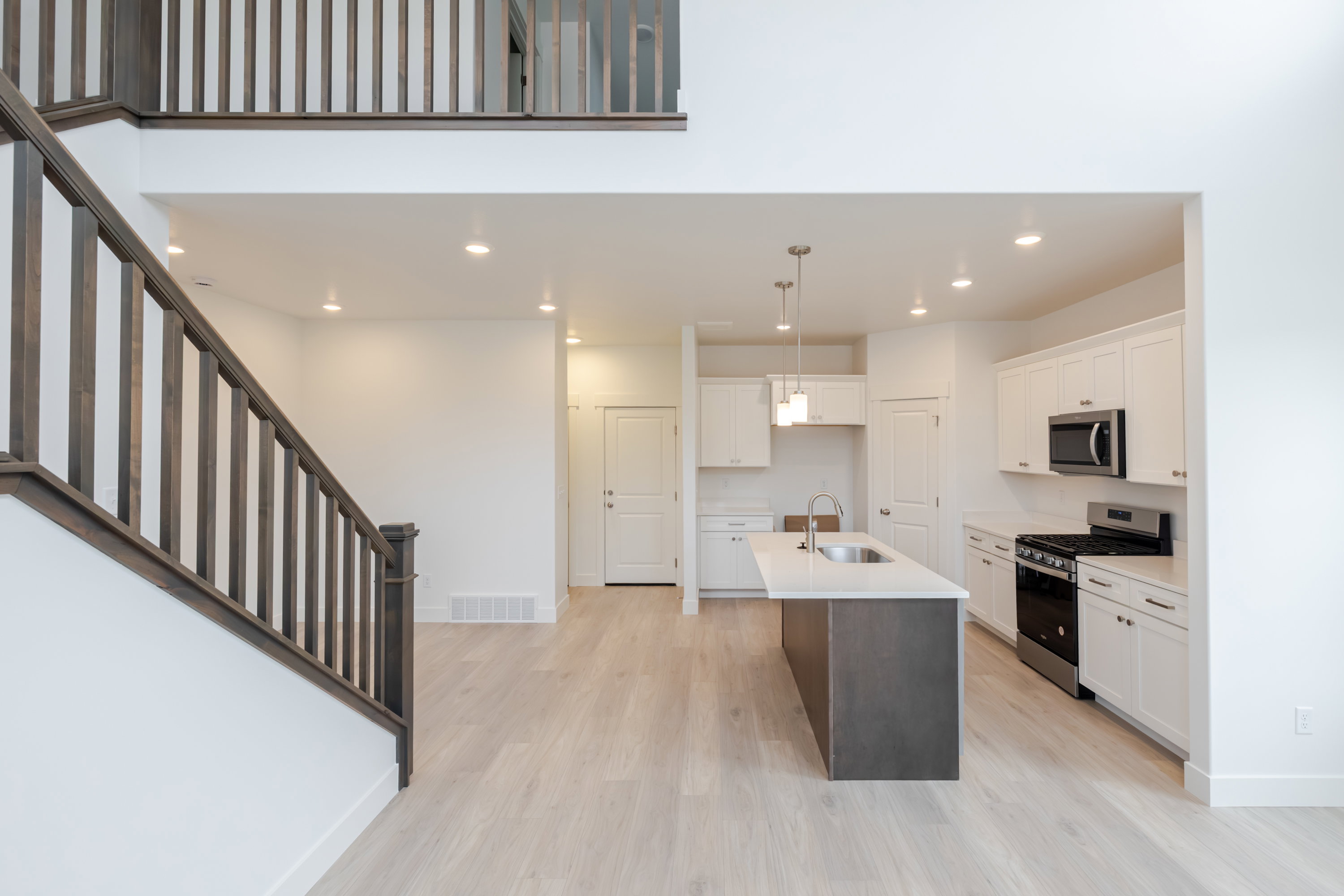 Modern kitchen with white cabinetry and stainless steel appliances