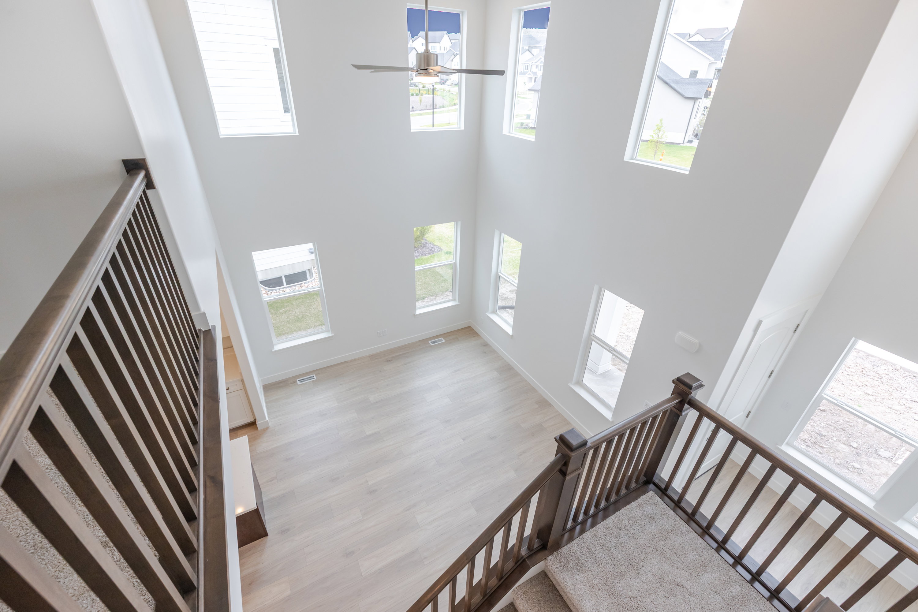 Two-story living area with light wood-finish flooring