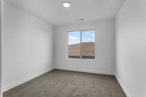 Carpeted empty room with baseboards