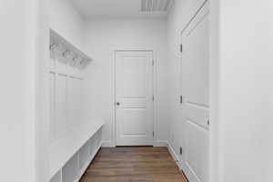 Mudroom with dark wood-style flooring