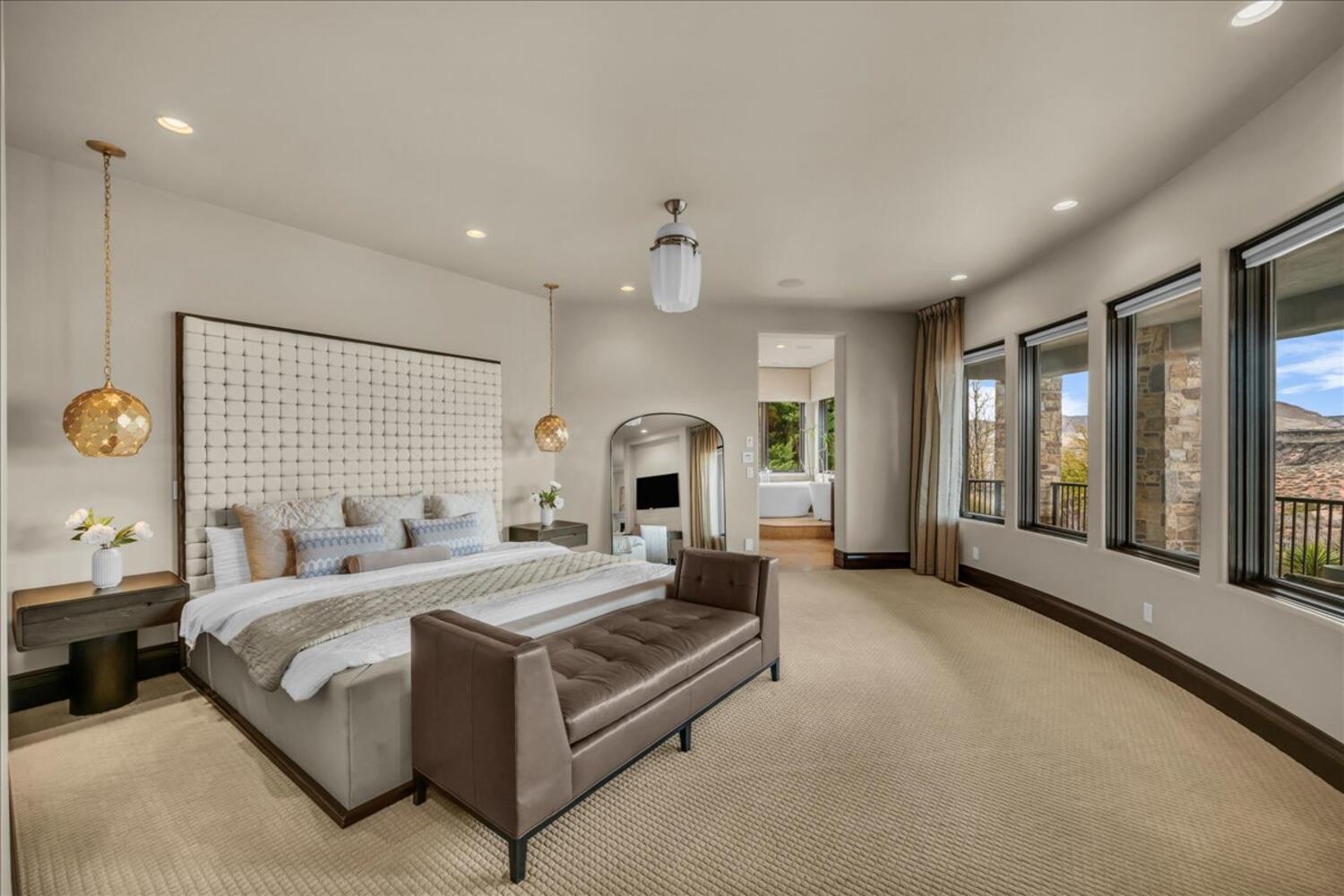 Bedroom featuring recessed lighting, arched walkways, and carpet flooring