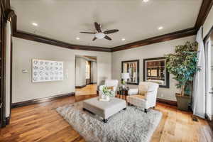 Living area featuring a ceiling fan, light wood-type flooring, crown molding, and recessed lighting