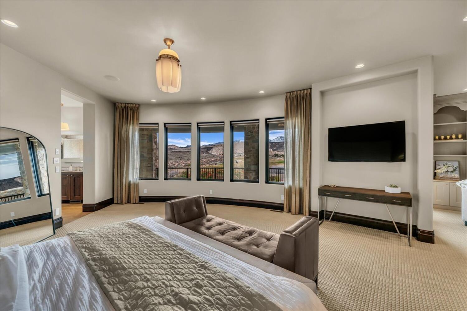 Bedroom featuring connected bathroom, light carpet, and recessed lighting