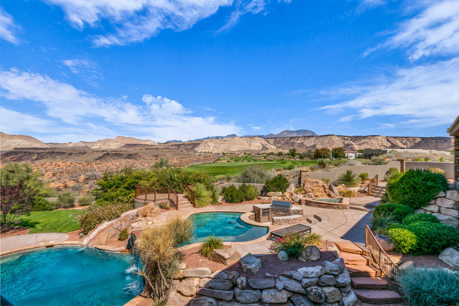 View of pool with a patio area, a mountain view, a water slide, and a hot tub