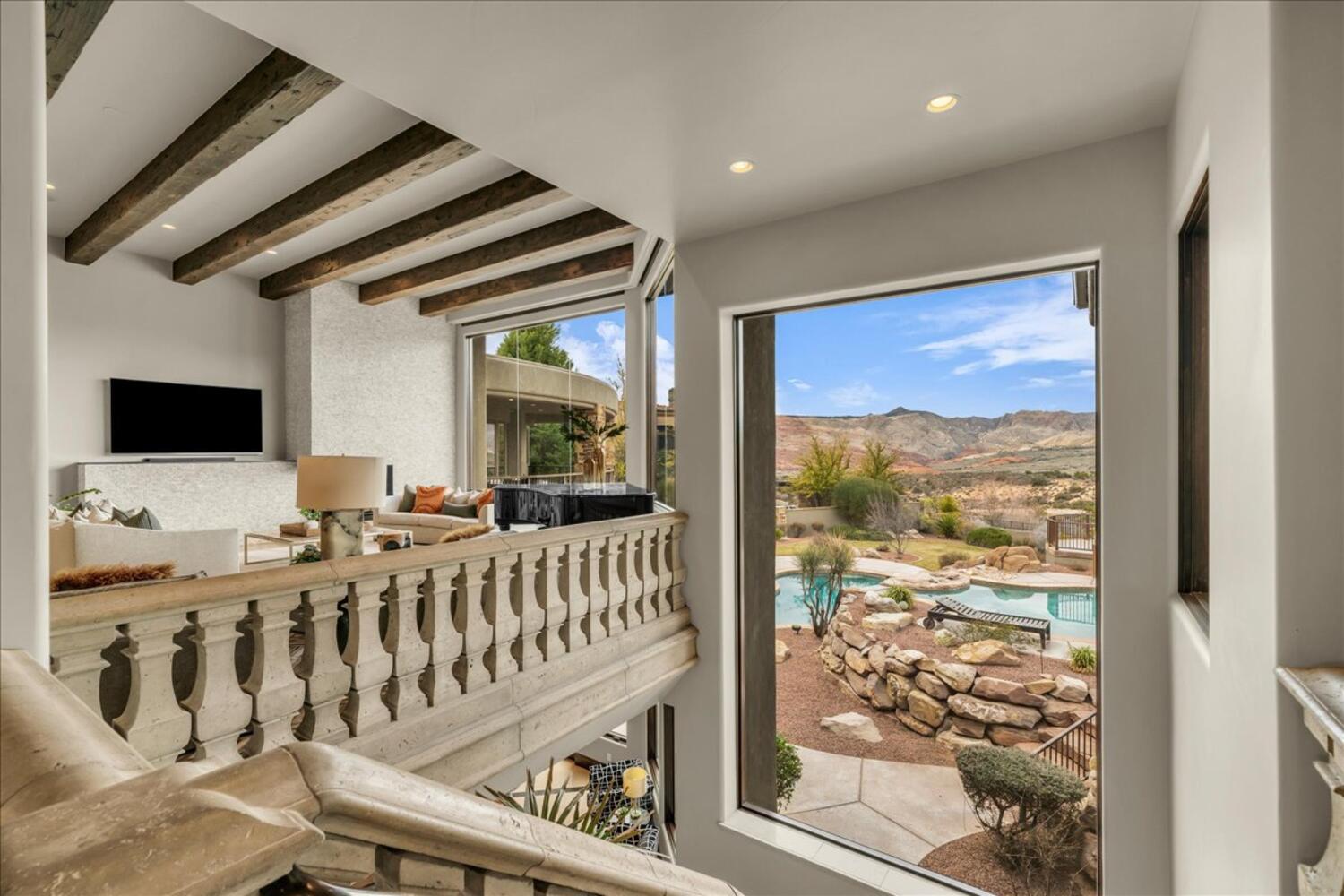 Living room featuring a mountain view, beam ceiling, and recessed lighting