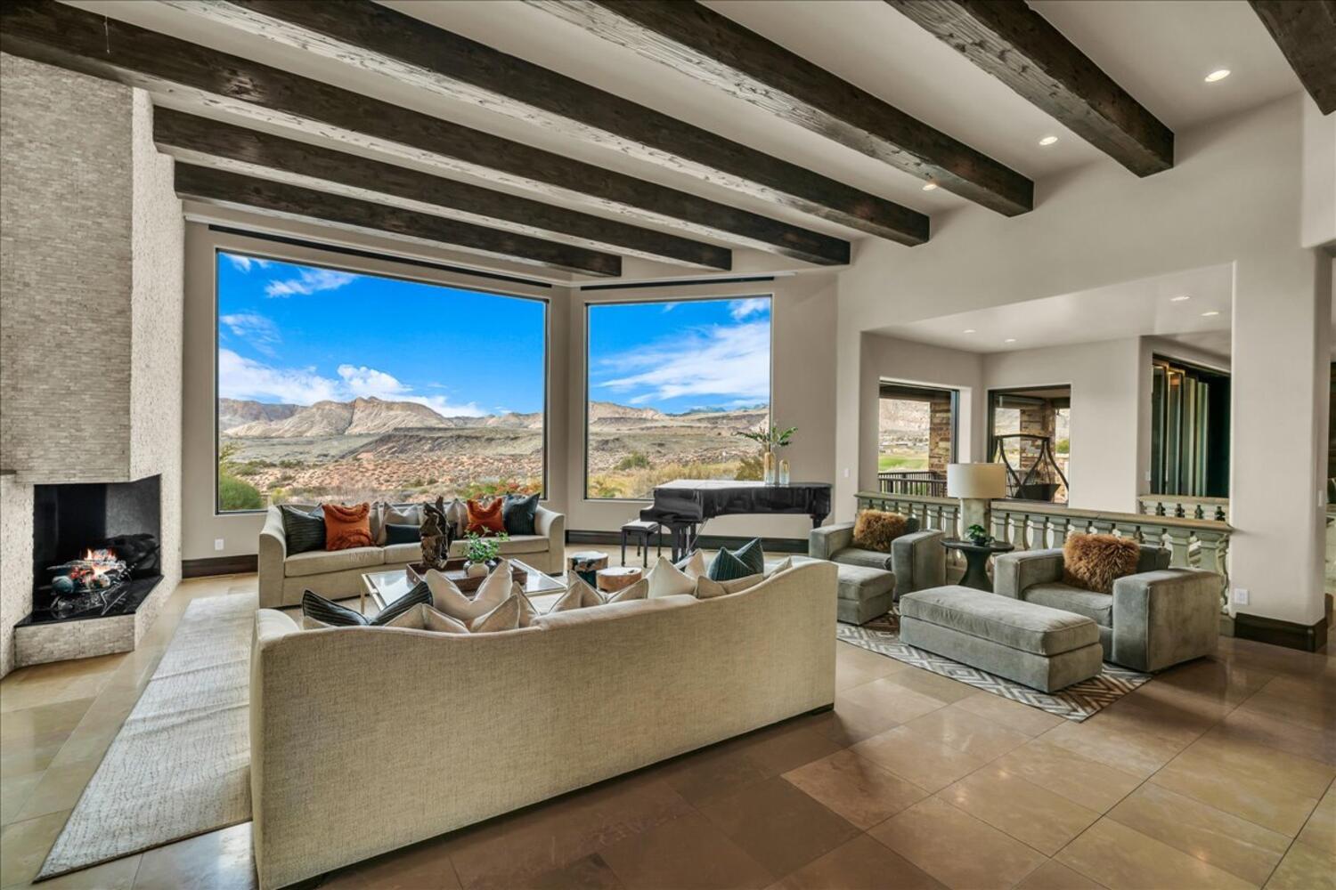 Living area with beamed ceiling, a mountain view, a large fireplace, recessed lighting, and tile patterned flooring