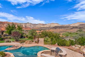 Outdoor pool with a patio, a mountain view, a jacuzzi, and area for grilling