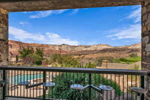 Balcony with a mountain view and view of pool area