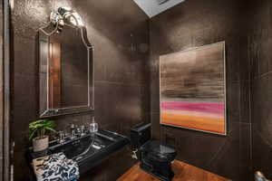 Half bathroom featuring toilet and a sink