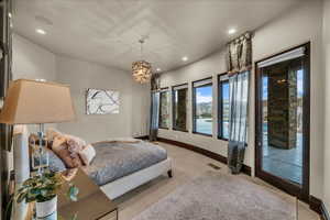 Carpeted bedroom with access to exterior, a chandelier, and recessed lighting