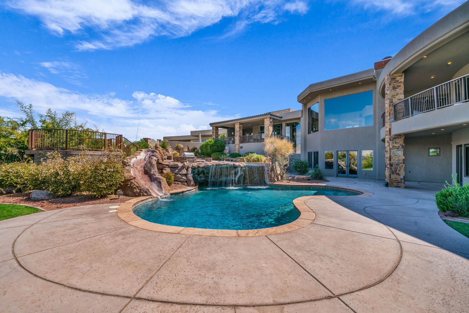 Swimming pool with a patio, a balcony, and a water slide