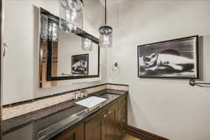 Bathroom with tasteful backsplash and vanity