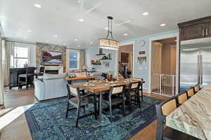 Dining room featuring dark wood-style floors, recessed lighting, and stairway