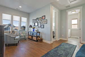 Sitting room featuring hardwood / wood-style flooring and recessed lighting